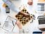 Professionals using a chessboard to represent strategic decision-making when comparing JBCC contracts, FIDIC contracts and NEC contracts.